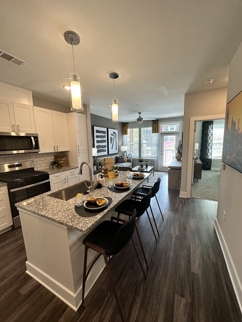 a kitchen with a large island with a breakfast bar